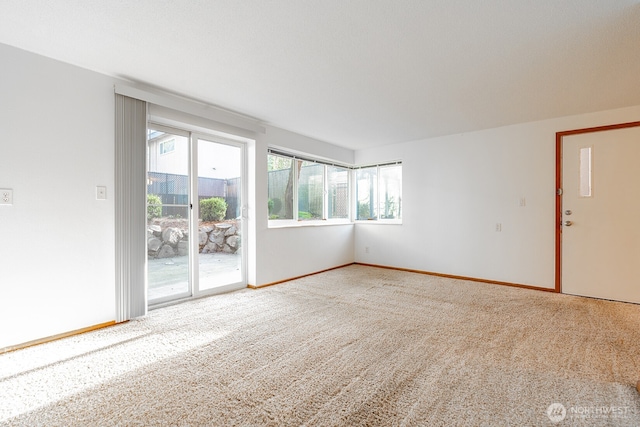 4456 Whitman Ave N, Seattle, WA 98103 - carpeted spare room featuring baseboards
