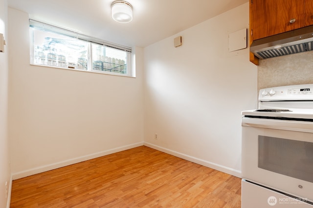 4456 Whitman Ave N, Seattle, WA 98103 - kitchen with electric stove, ventilation hood, light wood finished floors, brown cabinets, and baseboards