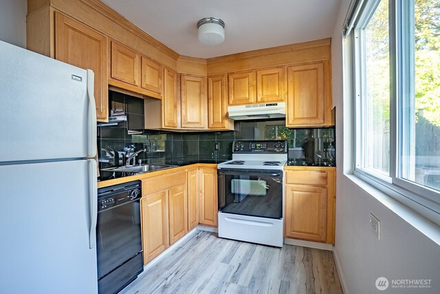 4456 Whitman Ave N, Seattle, WA 98103 - kitchen featuring white appliances, under cabinet range hood, a sink, backsplash, and light wood-type flooring