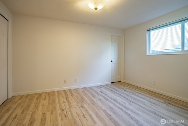 4456 Whitman Ave N, Seattle, WA 98103 - unfurnished bedroom featuring light wood-style floors, baseboards, and a closet