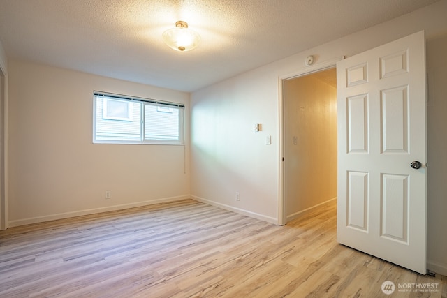 4456 Whitman Ave N, Seattle, WA 98103 - unfurnished room featuring light wood finished floors, baseboards, a smoke detector, and a textured ceiling