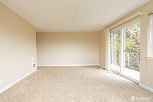 4456 Whitman Ave N, Seattle, WA 98103 - empty room featuring baseboards and light carpet