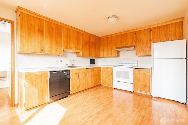 4456 Whitman Ave N, Seattle, WA 98103 - kitchen featuring white appliances, under cabinet range hood, a sink, and light countertops