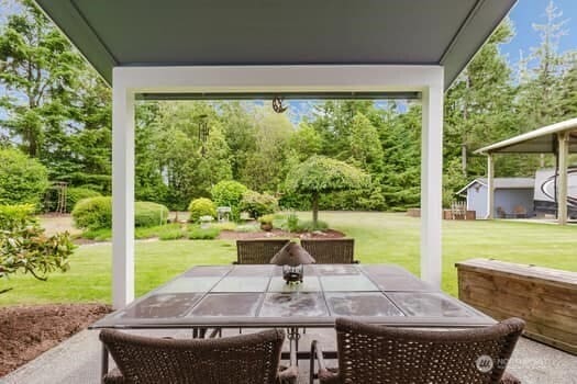 1155 Woods Rd SE, Port Orchard, WA 98366 - view of patio / terrace with view of scattered trees and outdoor dining area
