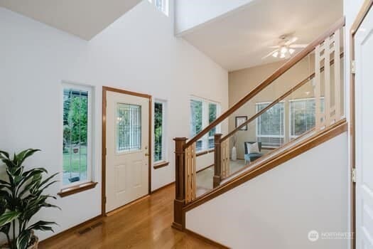 1155 Woods Rd SE, Port Orchard, WA 98366 - foyer entrance featuring stairs, wood finished floors, a ceiling fan, and a towering ceiling