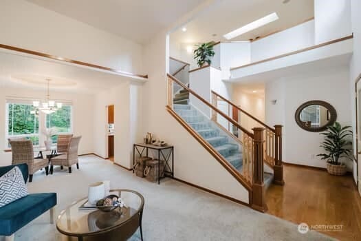 1155 Woods Rd SE, Port Orchard, WA 98366 - living area with stairway, a chandelier, and carpet flooring
