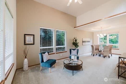 1155 Woods Rd SE, Port Orchard, WA 98366 - living area featuring carpet floors, a chandelier, and ceiling fan