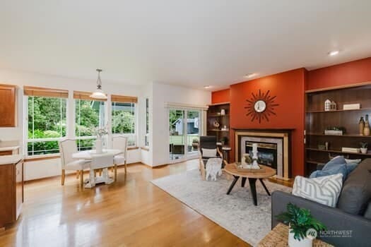 1155 Woods Rd SE, Port Orchard, WA 98366 - living room with a glass covered fireplace, light wood-style flooring, and built in features