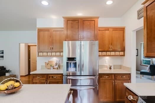 1155 Woods Rd SE, Port Orchard, WA 98366 - kitchen featuring stainless steel fridge with ice dispenser, light countertops, brown cabinets, recessed lighting, and range