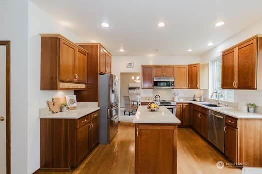 1155 Woods Rd SE, Port Orchard, WA 98366 - kitchen with stainless steel appliances, a kitchen island, light wood-type flooring, light countertops, and recessed lighting