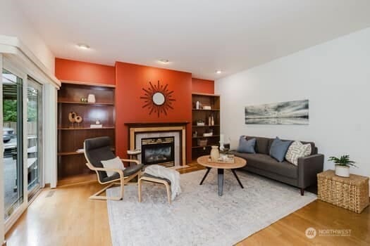 1155 Woods Rd SE, Port Orchard, WA 98366 - living area featuring wood finished floors and a fireplace with flush hearth