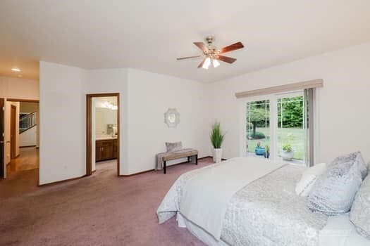 1155 Woods Rd SE, Port Orchard, WA 98366 - carpeted bedroom with a ceiling fan and connected bathroom