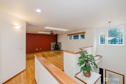 1155 Woods Rd SE, Port Orchard, WA 98366 - corridor with wood finished floors and an upstairs landing