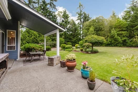 1155 Woods Rd SE, Port Orchard, WA 98366 - view of patio / terrace featuring outdoor dining area and view of wooded area