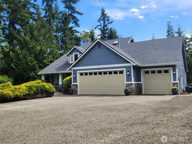 1155 Woods Rd SE, Port Orchard, WA 98366 - craftsman house with stone siding, an attached garage, concrete driveway, and roof with shingles