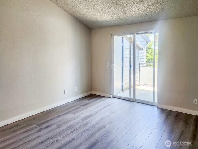 2611 NE 4th St Unit 234, Renton, WA 98056 - spare room with a textured ceiling, wood finished floors, and baseboards