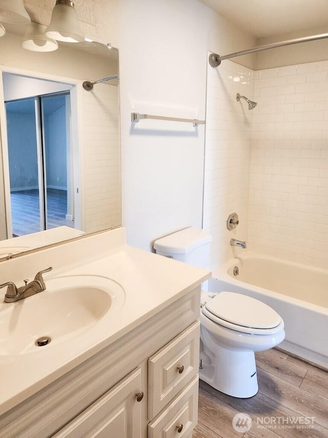 2611 NE 4th St Unit 234, Renton, WA 98056 - bathroom with vanity, wood finished floors, toilet, and tub / shower combination