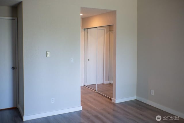 2611 NE 4th St Unit 234, Renton, WA 98056 - unfurnished bedroom featuring wood finished floors, baseboards, a closet, and recessed lighting