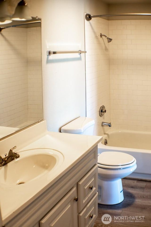2611 NE 4th St Unit 234, Renton, WA 98056 - full bathroom featuring vanity, toilet, wood finished floors, and shower / tub combination