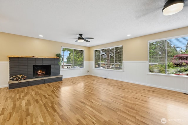 104 Hawthorn Ln, Shelton, WA 98584 - unfurnished living room featuring wainscoting, wood finished floors, plenty of natural light, a ceiling fan, and recessed lighting