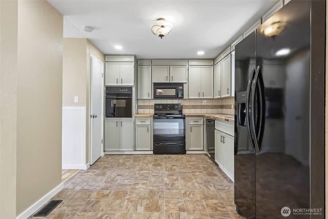 104 Hawthorn Ln, Shelton, WA 98584 - kitchen featuring black appliances, tasteful backsplash, stone finish floors, light countertops, and baseboards