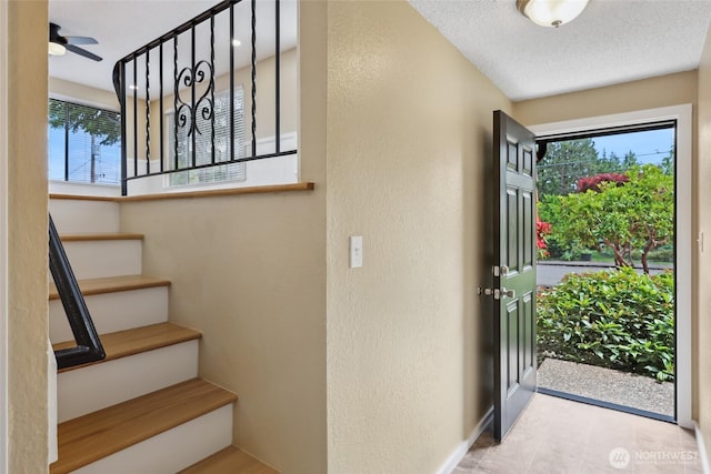 104 Hawthorn Ln, Shelton, WA 98584 - entryway with stairway, a textured wall, baseboards, and ceiling fan
