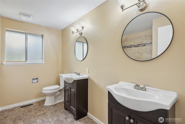 104 Hawthorn Ln, Shelton, WA 98584 - full bathroom featuring two vanities, baseboards, toilet, and stone finish flooring