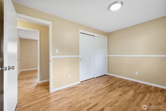 104 Hawthorn Ln, Shelton, WA 98584 - unfurnished bedroom featuring wood finished floors, baseboards, and a closet