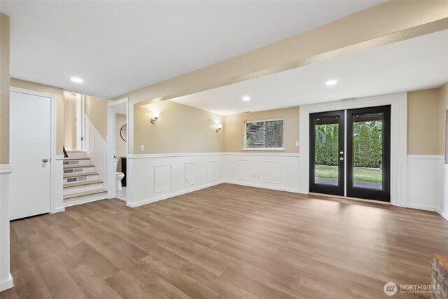 104 Hawthorn Ln, Shelton, WA 98584 - basement with stairway, wood finished floors, a wainscoted wall, a decorative wall, and recessed lighting