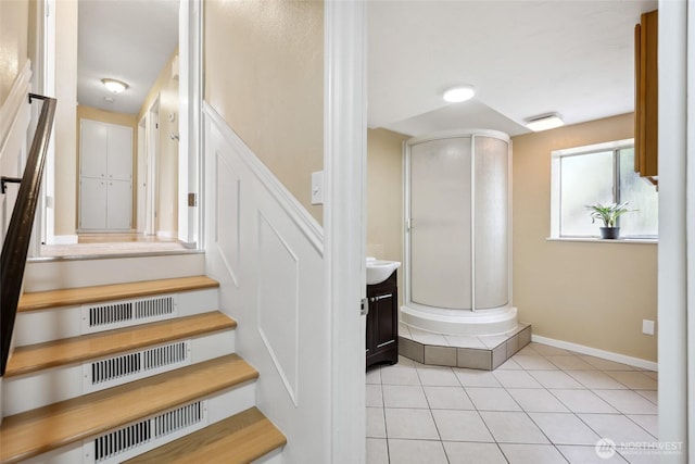 104 Hawthorn Ln, Shelton, WA 98584 - staircase with baseboards, tile patterned flooring, and decorative columns