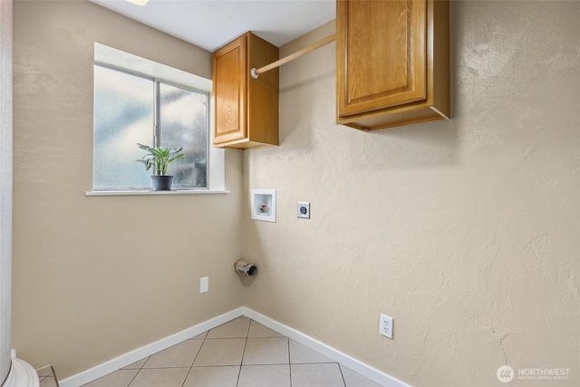 104 Hawthorn Ln, Shelton, WA 98584 - laundry room with electric dryer hookup, washer hookup, light tile patterned floors, cabinet space, and baseboards