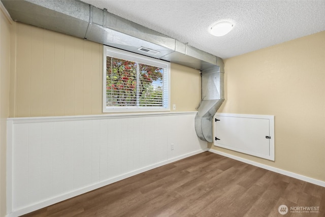104 Hawthorn Ln, Shelton, WA 98584 - below grade area with wood finished floors, baseboards, and a textured ceiling