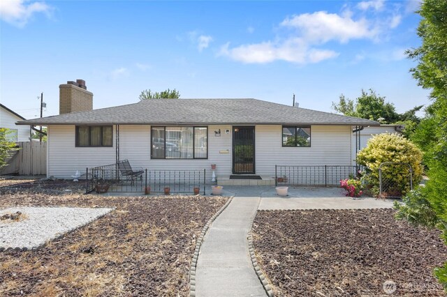 515 N Clark Rd, Moses Lake, WA 98837 - ranch-style house featuring a chimney, a patio area, and a shingled roof