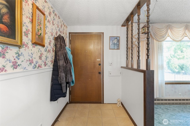 515 N Clark Rd, Moses Lake, WA 98837 - doorway featuring a baseboard radiator, a textured ceiling, wallpapered walls, a wainscoted wall, and light tile patterned flooring
