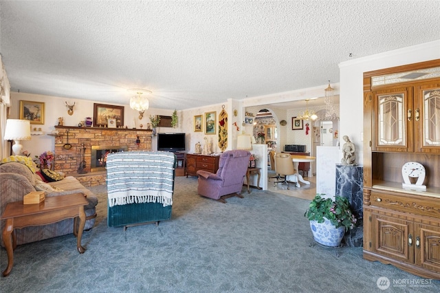 515 N Clark Rd, Moses Lake, WA 98837 - carpeted living area featuring a chandelier, a textured ceiling, and a warm lit fireplace