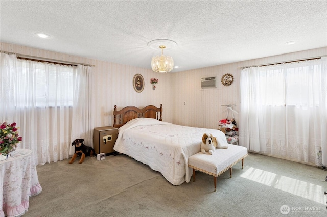 515 N Clark Rd, Moses Lake, WA 98837 - bedroom featuring carpet, a chandelier, a wall unit AC, a textured ceiling, and wallpapered walls