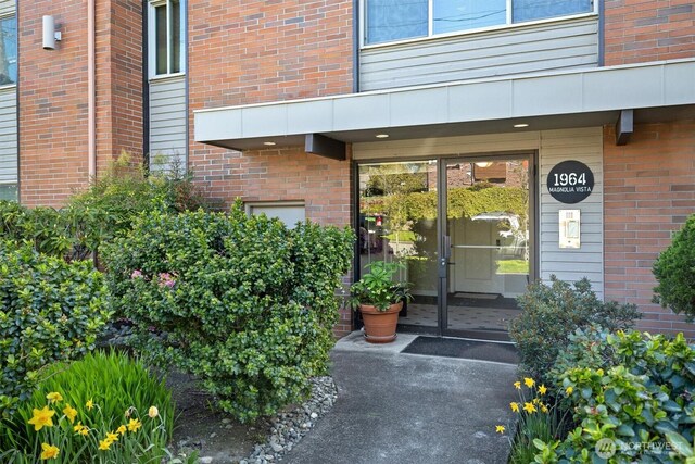 1964 26th Ave W Unit 102, Seattle, WA 98199 - doorway to property featuring brick siding