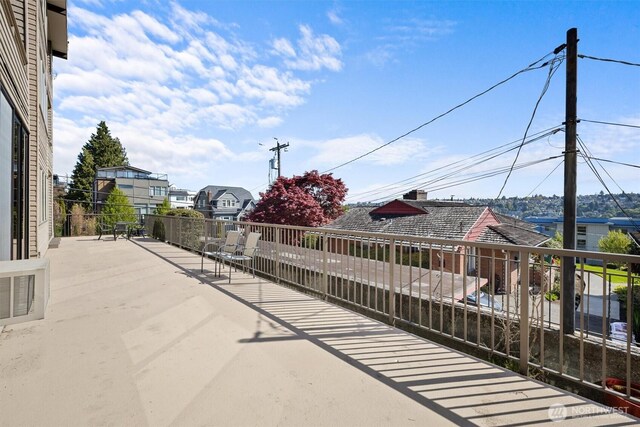 1964 26th Ave W Unit 102, Seattle, WA 98199 - view of patio / terrace featuring a balcony and a residential view