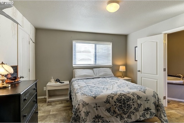 1693 N Sheperd Rd Unit 14, Washougal, WA 98671 - bedroom with wood finished floors and a textured ceiling