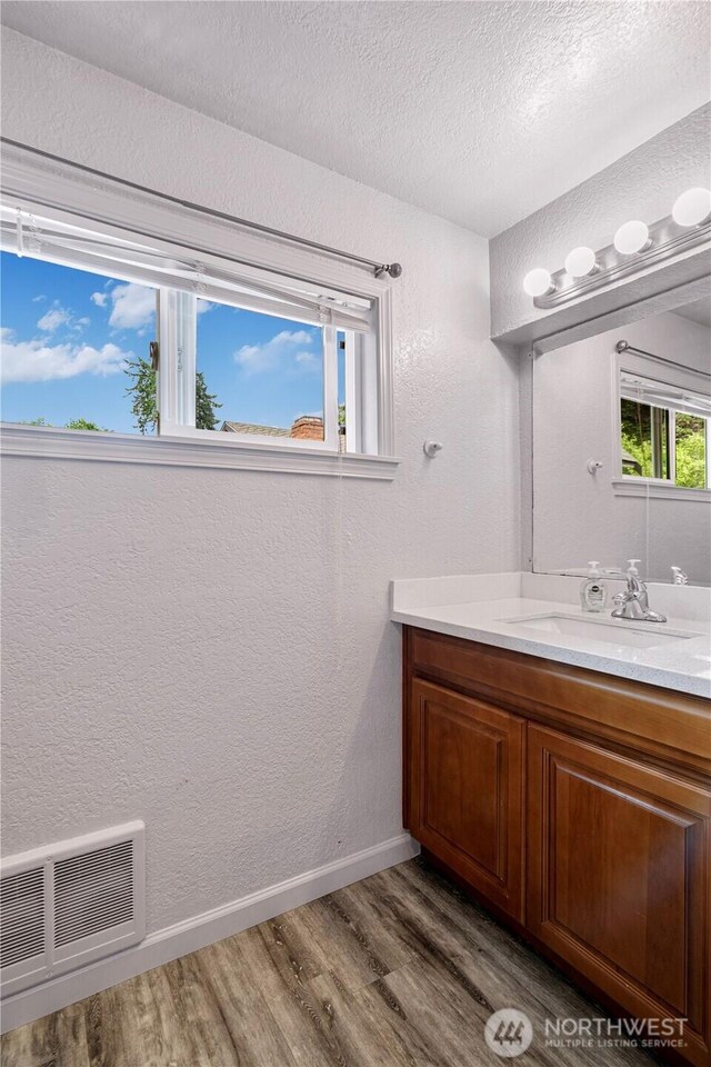31111 53rd Ave SW, Federal Way, WA 98023 - bathroom with wood finished floors, vanity, a textured ceiling, baseboards, and a textured wall