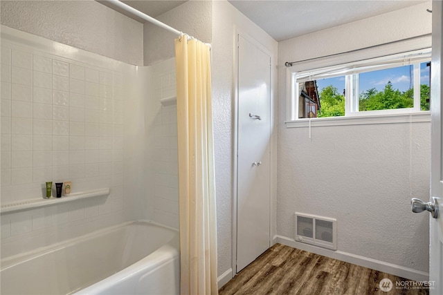 31111 53rd Ave SW, Federal Way, WA 98023 - bathroom featuring wood finished floors, a textured wall, shower / bathtub combination with curtain, and baseboards