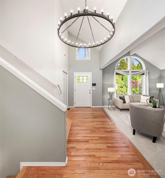 6513 156th Ave SE, Bellevue, WA 98006 - foyer with high vaulted ceiling, a chandelier, light wood-type flooring, stairway, and baseboards