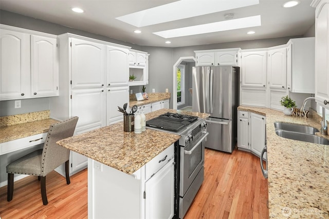 6513 156th Ave SE, Bellevue, WA 98006 - kitchen with a sink, appliances with stainless steel finishes, a skylight, a kitchen island, and recessed lighting