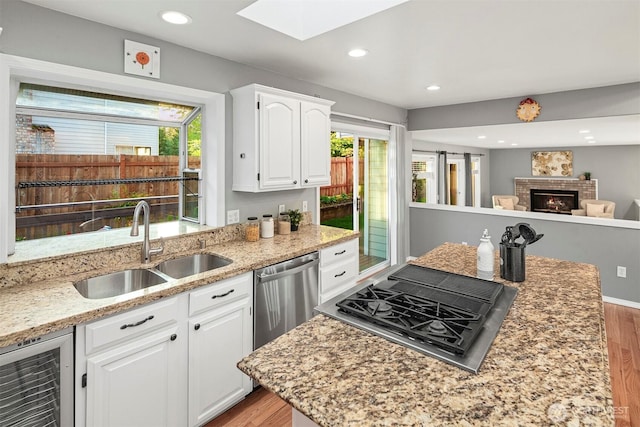 6513 156th Ave SE, Bellevue, WA 98006 - kitchen with a sink, beverage cooler, stainless steel dishwasher, light wood-type flooring, and recessed lighting