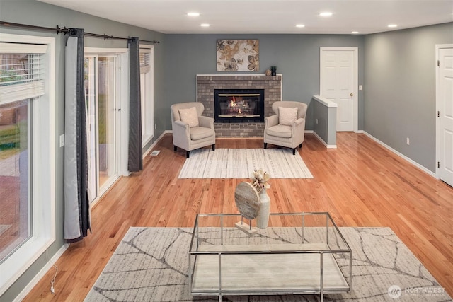 6513 156th Ave SE, Bellevue, WA 98006 - living area with a brick fireplace, baseboards, light wood-style flooring, recessed lighting, and healthy amount of natural light