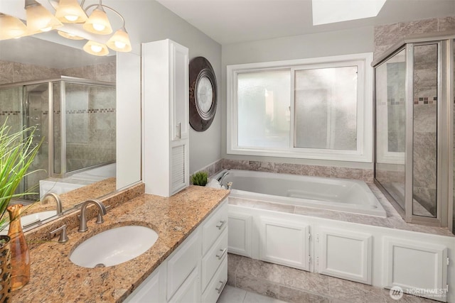 6513 156th Ave SE, Bellevue, WA 98006 - bathroom featuring a shower stall, vanity, a bath, tile patterned floors, and a skylight