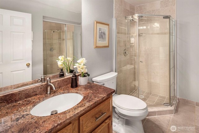 6513 156th Ave SE, Bellevue, WA 98006 - bathroom featuring toilet, vanity, a stall shower, and tile patterned floors