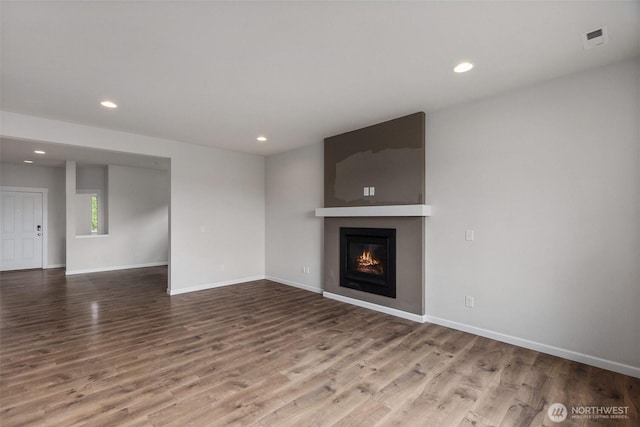 2719 Fiddleback St NE, Lacey, WA 98516 - unfurnished living room featuring wood finished floors, recessed lighting, baseboards, and a large fireplace