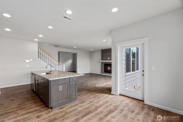 2719 Fiddleback St NE, Lacey, WA 98516 - kitchen with a sink, dark brown cabinets, light wood-style floors, baseboards, and recessed lighting