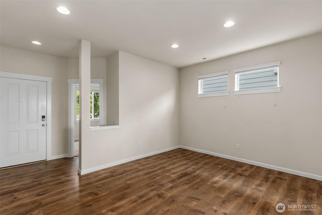 2719 Fiddleback St NE, Lacey, WA 98516 - empty room with healthy amount of natural light, dark wood-style flooring, baseboards, and recessed lighting